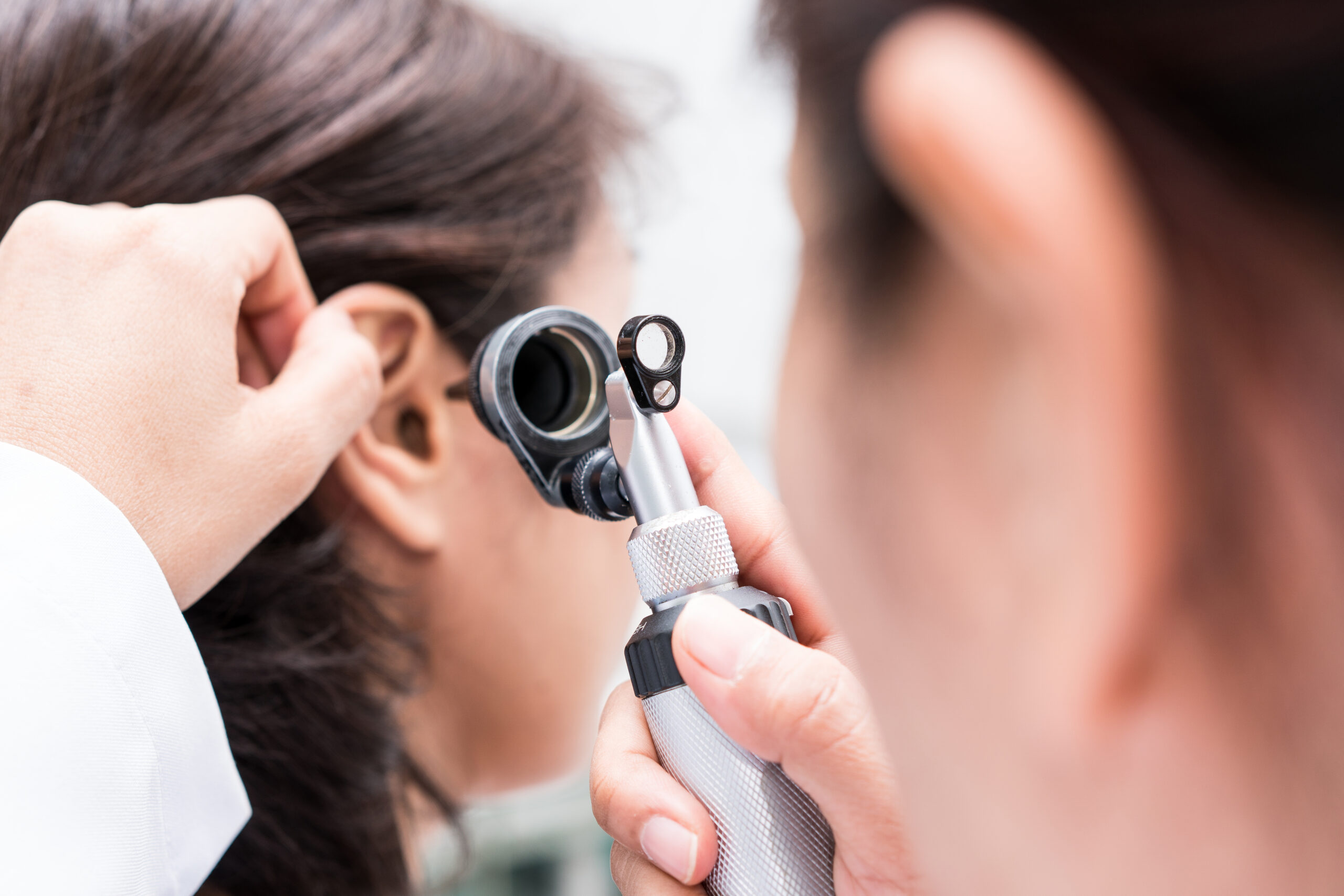 Doctor examined the patient’s ear with Otoscope. Patient seem to