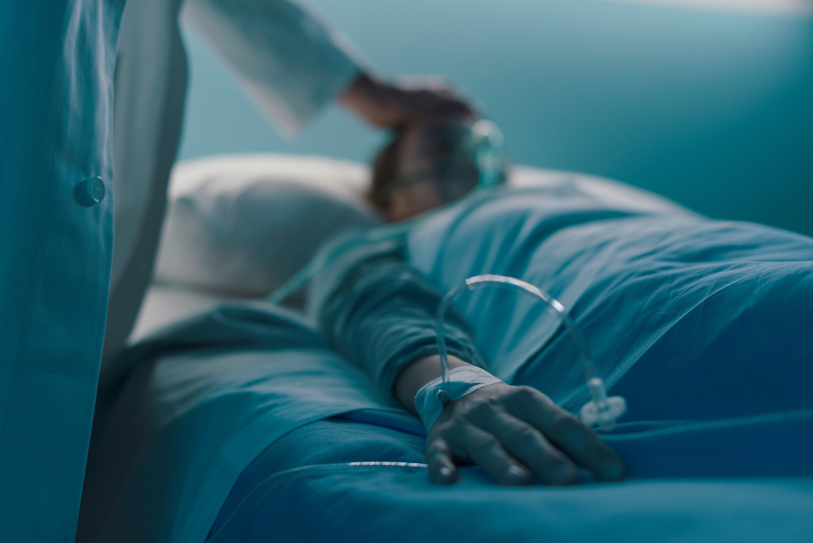 Hospitalized patient lying in a hospital bed