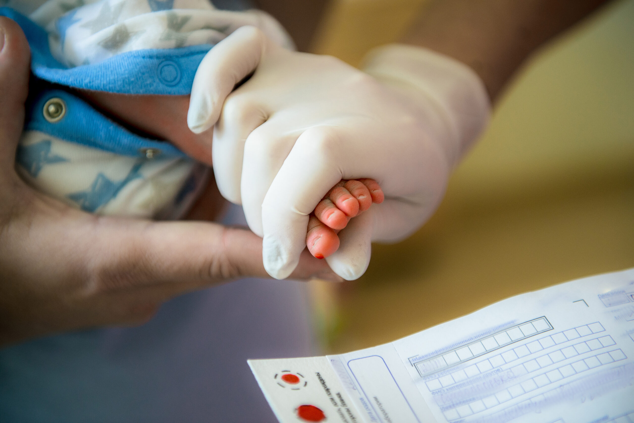 doctor takes a blood test in newborns